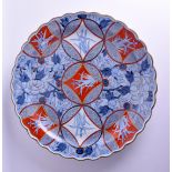 A VERY LARGE 19TH CENTURY JAPANESE MEIJI PERIOD SCALLOPED IMARI CHARGER painted with floral sprays.