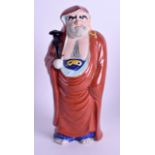 A 19TH CENTURY JAPANESE MEIJI PERIOD PORCELAIN FIGURE OF A SCHOLAR modelled holding a rui sceptre. 2