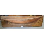 AN EARLY 20TH CENTURY WOODEN YACHT WALL PLAQUE, fitted to a rectangular panel. 31 cm x 110 cm.