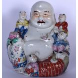 A CHINESE REPUBLICAN PERIOD PORCELAIN BUDDHA, modelled seated with young children. 21.5 cm.