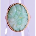 AN EARLY 20TH CENTURY CHINESE 9CT GOLD MOUNTED JADEITE RING. 4.3 grams. Jadeite 1.25 cm x 1 cm.