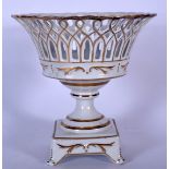 A MEISSEN PORCELAIN RETICULATED BASKET ON STAND, painted with gilt highlights. 23.5 cm high.