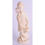 A 19TH CENTURY JAPANESE MEIJI PERIOD CARVED IVORY OKIMONO modelled as a geisha holding a basket of f