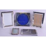 AN ANTIQUE CONTINENTAL SILVER PHOTOGRAPH FRAME together with four others. Largest 18 cm x 18 cm. (5)