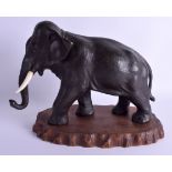 A LARGE 19TH CENTURY JAPANESE MEIJI PERIOD BRONZE OKIMONO modelled as a roaming elephant. 30 cm x 21