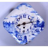 A DUTCH BLUE AND WHITE ENAMEL WALL CLOCK, decorated with a rural landscape. 24 cm wide.