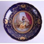 AN EARLY 20TH CENTURY VIENNA PORCELAIN COMPORT painted with two lovers within a landscape, under a b