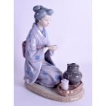 A LLADRO FIGURE OF AN ORIENTAL LADY modelled drinking tea. 24 cm x 15 cm.