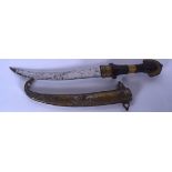 AN EARLY 20TH CENTURY ISLAMIC DAGGER, formed with a curving blade and wooden handle. 41 cm long.