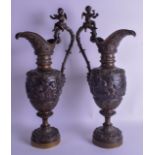 A VERY LARGE PAIR OF 19TH CENTURY ITALIAN BRONZE CLASSICAL EWERS decorated with classical figures un