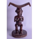 AN EARLY 20TH CENTURY AFRICAN TRIBAL CARVED HARDWOOD HEADREST modelled as a female. 30 cm x 18 cm.