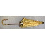 A 20TH CENTURY UMBRELLA, carved with the head of a duck. 91 cm long.