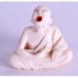 A 19TH CENTURY JAPANESE MEIJI PERIOD CARVED IVORY NETSUKE modelled as a howling male tickling himsel