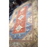 A LARGE BEIGE GROUND RUG, decorated with motifs and symbols. 384 cm x 262 cm.