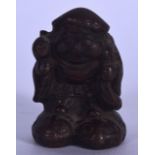 A CHINESE BRONZE FIGURE OR STATUE IN THE FORM OF A MALE, modelled standing with a bulging sack over