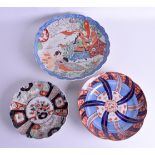 THREE 19TH CENTURY JAPANESE MEIJI PERIOD IMARI DISHES in various forms. Largest 32 cm wide. (3)