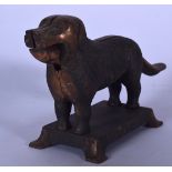 A NOVELTY NUTCRACKER IN THE FORM OF A STANDING DOG, modelled upon a rectangular plinth. 29 cm wide.