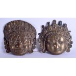 A PAIR OF 19TH CENTURY SOUTH EAST ASIAN TIBETAN BRASS MASKS in the form of buddhists. 24 cm x 24 cm.