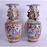 A PAIR OF 19TH CENTURY CHINESE FAMILLE ROSE VASES Qing, painted with figures within landscapes. 24 c