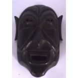 A WOODEN TRIBAL MASK, carved with elongated features. 28.5 cm long.