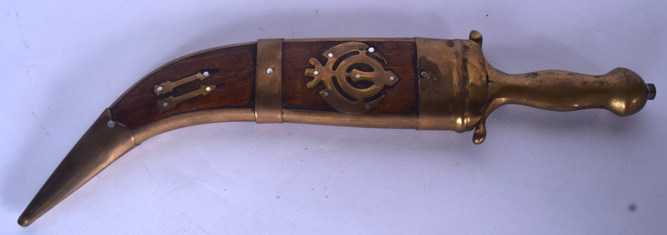 A 20TH CENTURY BRASS HANDLED DAGGER, formed with curving blade and wooden inlaid sheath. 33 cm long.