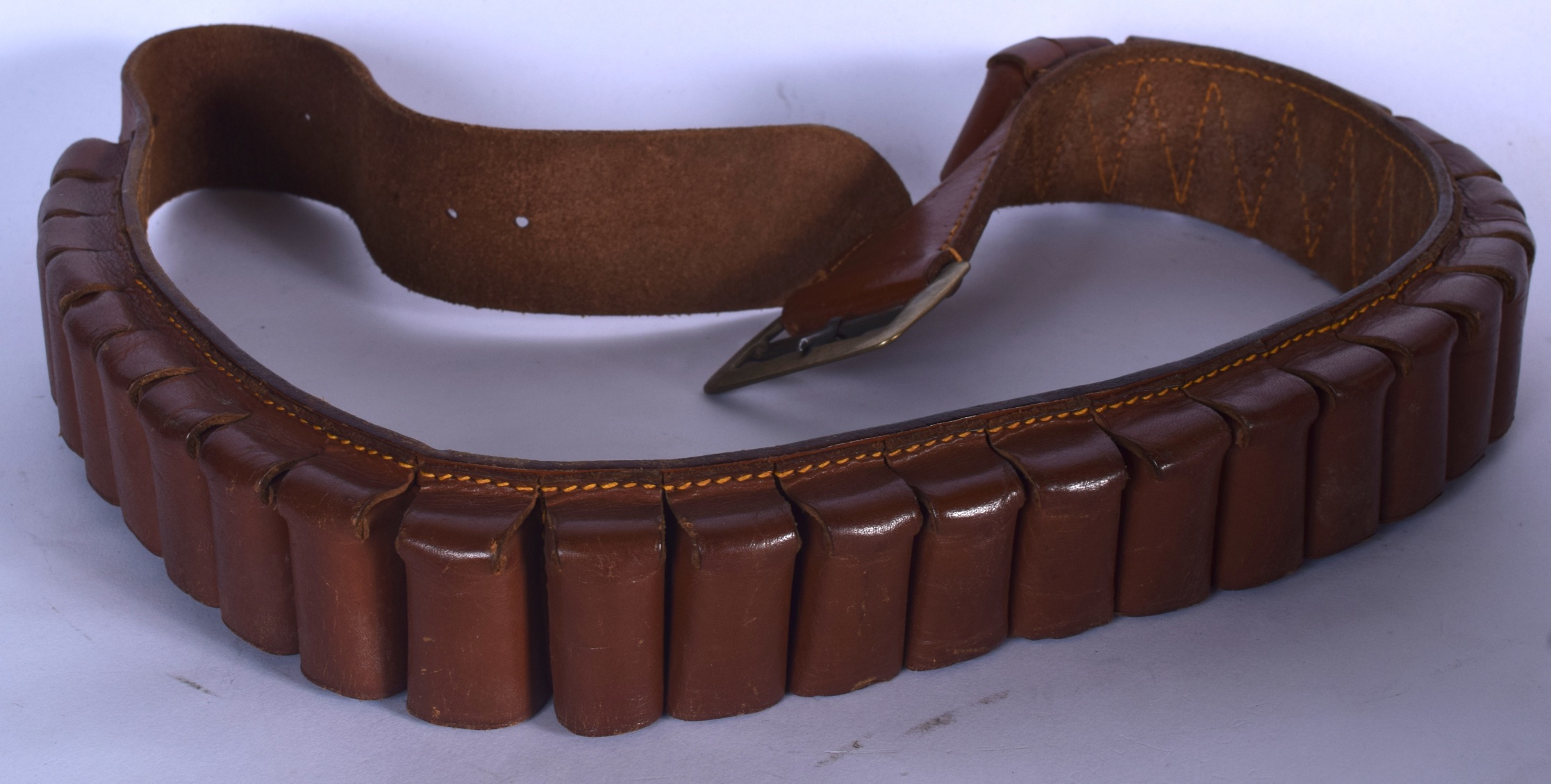 AN EARLY 20TH CENTURY LEATHER AMMUNITION BELT. 104 cm long.