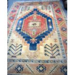 A 20TH CENTURY TURKISH VILLAGE RUG, decorated with symbols. 295 cm x 206 cm.