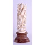 A 19TH CENTURY ANGLO INDIAN CARVED IVORY FIGURE OF A MUSICIAN modelled upon a lotus flower. Ivory 16
