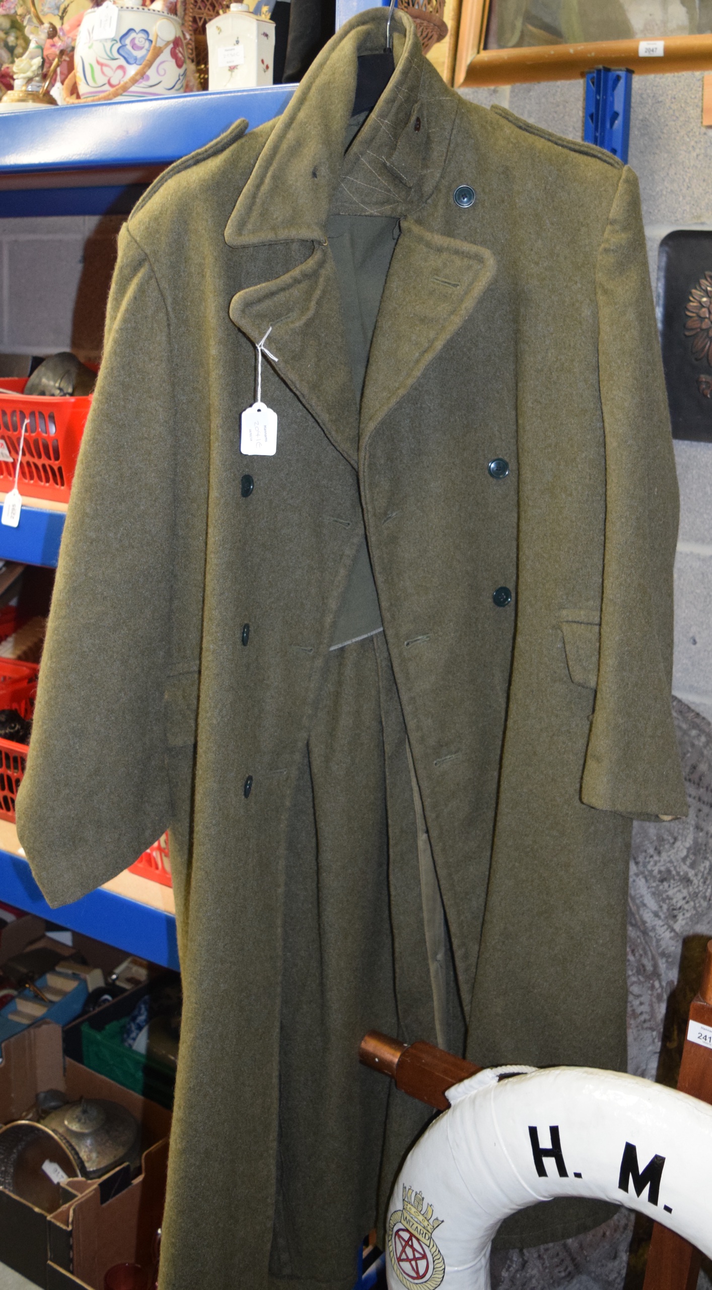 A LONG GREEN MILITARY COAT. 137 cm long.