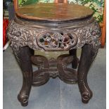 A LARGE 19TH CENTURY JAPANESE MEIJI PERIOD CARVED HARDWOOD STAND decorated with buddhistic mask head