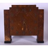 AN EARLY 20TH CENTURY ART DECO BURR WALNUT CLOCK, formed on rectangular pillar supports and brass nu