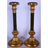 A LARGE PAIR OF GILTWOOD CANDLESTICKS, formed on a pedestal base with velvet covered stem. 44 cm hig