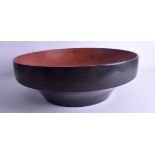 A LARGE 18TH CENTURY JAPANESE EDO PERIOD RED AND BLACK LACQUER BOWL of plain form. 40 cm x 15 cm.