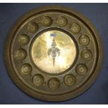 A LARGE EASTERN BRASS CHARGER, decorated with foliage. 64 cm wide.