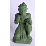 A 19TH CENTURY SOUTH EAST ASIAN GREEN POTTERY FIGURE OF A MALE modelled kneeling holding a dog. 18 c