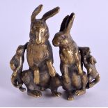 A 19TH CENTURY BRONZE GROUP OF RABBITS modelled upon their haunches. 8.5 cm x 7.5 cm.