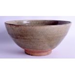 A CHINESE QING DYNASTY CELADON POTTERY BOWL of flared form. 20 cm x 10 cm.