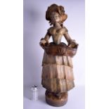 A VERY LARGE ANTIQUE AUSTRIAN COLD PAINTED TERRACOTTA GOLDSCHEIDER FIGURE modelled as a female holdi