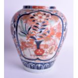 A 19TH CENTURY JAPANESE MEIJI PERIOD IMARI VASE painted with flowers and fenced gardens. 24 cm x 18