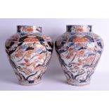 A LARGE PAIR OF 18TH CENTURY JAPANESE EDO PERIOD IMARI VASES painted with birds and foliage. 34 cm x