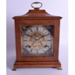 AN ANTIQUE OAK MANTEL CLOCK with brass cherub dial. 25 cm x 17 cm.