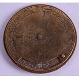 A RARE 17TH CENTURY BRASS REVOLVING POCKET CALENDER possibly German, decorated with script. 4.75 cm