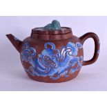 A 19TH CENTURY CHINESE ENAMELLED YIXING POTTERY TEAPOT AND COVER painted with buddhistic lions. 17 c