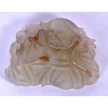 A 19TH CENTURY CHINESE WHITE JADE CARVED PLAQUE, formed as a seated male beside foliage. 2.8 cm wide