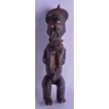 AN UNUSUAL EARLY 20TH CENTURY AFRICAN TRIBAL FERTILITY FIGURE modelled as a bearded male wearing a c