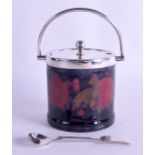 A WILLIAM MOORCROFT POMEGRANATE PRESERVE JAR AND COVER with silver plated mounts. 13 cm inc handle.