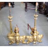 A PAIR OF VICTORIAN ANDIRONS FORMED WITH LION MASK HEADS, together with a pair of candlesticks. Andi