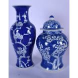 A CHINESE BLUE AND WHITE PORCELAIN VASE AND COVER, together with a baluster vase decorated with prun