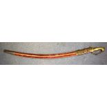 A MID 20TH CENTURY INDIAN SABRE OR SABRE SWORD, formed with beast handle and velvet scabbard. 98 cm