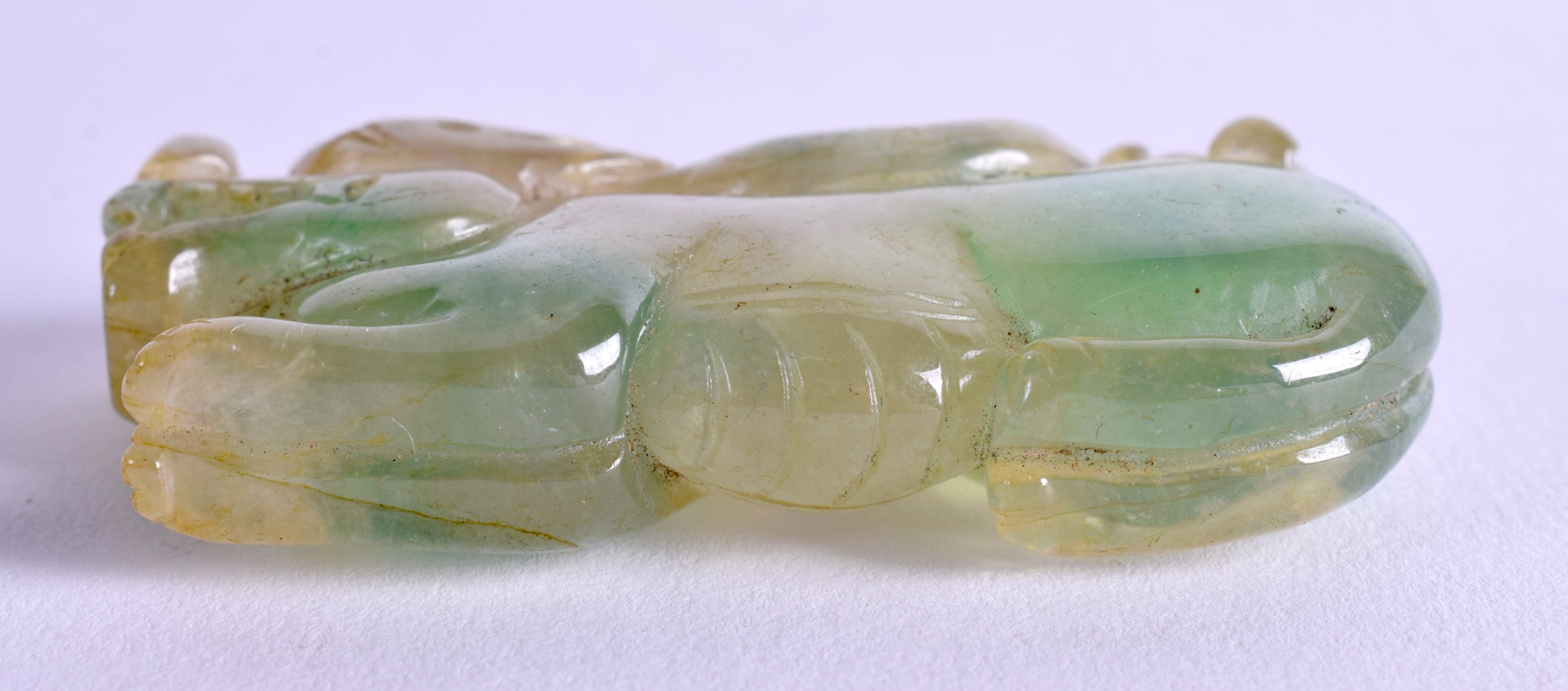 A CHINESE CARVED JADEITE BEAST AMULET. 6 cm wide. - Image 3 of 3